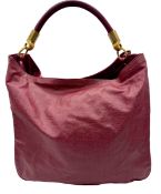 A Yves Saint Laurent Roady Hobo Bag. Burgundy leather exterior with gold-tone hardware and a