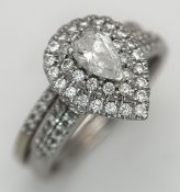 Two 18K White Gold Diamond Rings. A 0.50ct pair cut diamond with a further 0.50ctw of surround and