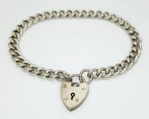 A silver heart padlock charm bracelet. Total weight 15.8G. Total length 18cm.
