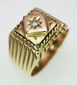 A 14K Yellow Gold (tests as) Diamond Signet Ring. Ridged band decoration with a raised deep set