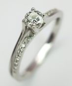 An 18K White Gold Diamond Ring. A round brilliant cut 0.25ct diamond having G-H colour with VS2