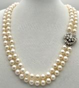 A Two Row Freshwater Pearl Necklace with a Floral Form 18K White Gold (tests as) and c. 1.5ctw round