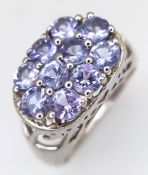 A Stylish Sterling Silver and Tanzanite Set Ring Size N. The Ring is set with Ten 4mm Round Cut