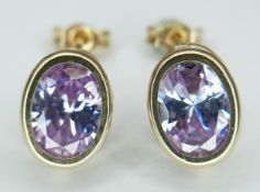 A Pretty Pair of 9k Yellow Gold and Amethyst Stud Earrings. Set with 8 x 6mm Oval Cut Amethysts,