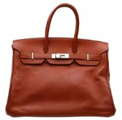 An Hermès Brick Red Courchevel Birkin 35 Handbag. Brick red Courchevel leather exterior with