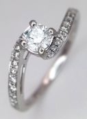 A PLATINUM, DIAMOND SET SOLITAIRE RING, WITH TWIST DIAMOND SET SHOULDERS. CENTRE DIAMOND IS ROUND