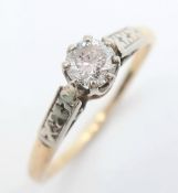 An 18K Gold and Platinum Diamond Solitaire Ring. 0.25ct round brilliant cut diamond. Size L 1/2.