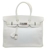 An Hermès White Epsom Birkin 35 Handbag. White Epsom leather exterior with silver-toned hardware,