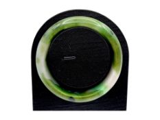 A Green Jade Bangle，circular form, carved from jade of variegated green and pale tones. Inner