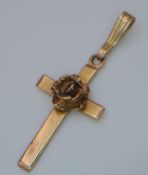 A 9K Yellow Gold Cross Pendant with Ornate Rose Decoration. 3cm. 1.11g