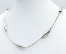 A 925 Silver Necklace with Oval Station Details. Approx 58cm length. Total weight: 11.03g. Comes