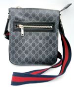 A Black Gucci GG Canvas Web Stripe Crossbody Bag. Black GG monogram canvas exterior with silver-tone