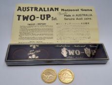 A vintage Australian 2 up game. Complete with redwood paddle and two 22ct gold plated pennies, dated