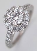 A Platinum (tests as) and Diamond Cocktail Ring. A 0.75ct round brilliant cut centre stone sits atop