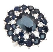 An 18K White Gold Sapphire and Diamond Cluster Cocktail Ring. Classic statement style. Centre oval