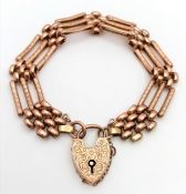 A 9K Rose Gold Fancy Gate Bracelet with Heart Clasp and Decorative Gates. Safety chain. Good