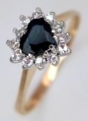 A 9K Yellow Gold Heart Shaped Sapphire and Diamond Surround Ring. Size P 1/2. 1.7g total weight.