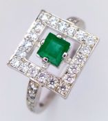 An 18K White Gold (tests as) Emerald and Diamond Target Form Cocktail Ring. 0.35ct square cut centre