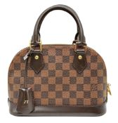 A Louis Vuitton Damier Ebene Alma BB Bag. Damier Ebene coated canvas exterior with dark brown