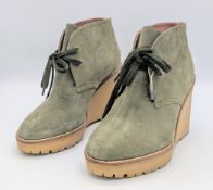 A Pair of REDValentino Olive Green Wedge Ankle Boots. Suede exterior with textile laces and rubber