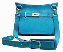 An Hermès Jypsière 31 Handbag. Turquoise pebbled leather exterior with silver-toned hardware,