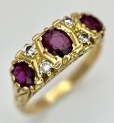 AN 18K GOLD 3 STONE GYPSY STYLE RING WITH LARGE RUBY STONES SEPERATED BY 4 DIAMONDS . 5.8gms size S