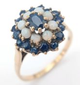 A 9K GOLD RING WITH A CLUSTER OF OPAL AND SAPPHIRES. 2.9fms size T