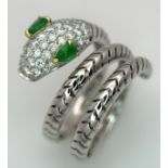 An 18K White Gold Diamond and Emerald Snake Ring. Emerald set eyes and round cut diamonds to the