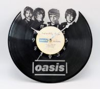 An Oasis Custom Made Wall Clock. Laser-cut used vinyl creates the iconic Definitely Maybe Album