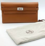 An Hermès Tan Epsom Leather Kelly Long Wallet. Tan Epsom leather exterior with silver-toned