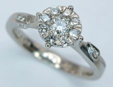 AN 18K WHITE GOLD, DIAMOND SET CLUSTER RING. 0.31CTW. 3.7G, SIZE M. SC 6087