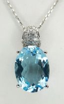 A Beautiful Oval Cut Blue Topaz, Diamond and 14k White Gold Pendant on a 14K White Gold Chain. C.