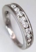 An 18K White Gold Channel Set Diamond Half Eternity Ring. 0.50ctw of 14 round brilliant cut diamonds