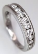 An 18K White Gold Channel Set Diamond Half Eternity Ring. 0.50ctw of 14 round brilliant cut diamonds
