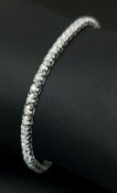 An 18K White Gold Diamond Tennis Bracelet. 64 round brilliant cut diamonds of c. 1ctw. 18cm