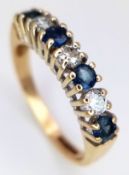 AN 18K YELLOW GOLD, DIAMOND AND SAPPHIRE, 7 STONE RING. 0.30CTW DIAMONDS AND 0.40CTW SAPPHIRES. 2.