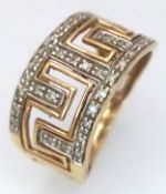 A 9K Yellow Gold and Diamond Band Ring with Geometric Openwork. 11mm widest part. Size N 1/2. 2.6g.