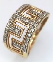 A 9K Yellow Gold and Diamond Band Ring with Geometric Openwork. 11mm widest part. Size N 1/2. 2.6g.