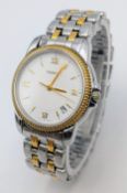 A Tissot Pack Quartz Unisex Watch. Two tone bracelet and case - 33mm. White dial with date window.