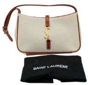 A Saint Laurent Le 5 à 7 Hand Bag. Beige canvas exterior with brown leather trim, gold-tone hardware