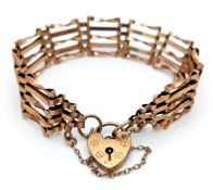 A Vintage 9K Yellow Gold Gate Bracelet with Heart Clasp and safety chain. 11mm width. 18cm. 12.2g.