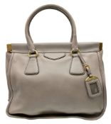 A Prada Taupe Leather Tote Bag. Taupe leather exterior with gold-tone hardware, double rolled