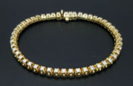 A Gorgeous 14K Yellow Gold Diamond Tennis Bracelet. 49 round brilliant cut diamonds of 2.5ctw having