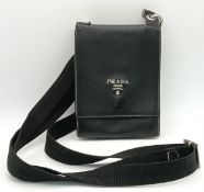 A PRADA BLACK LEATHER SMALL HANDBAG WITH SHOULDER STRAP AND CLIP FASTENING, TARTAN INTERIOR AND 3