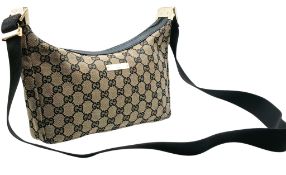 A Gucci GG Monogram Canvas Shoulder Bag. Beige and black GG monogram canvas exterior with black