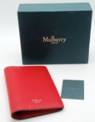 A Mulberry Lancaster Red Passport Cover. Leather interior and exterior with passport holding sleeve,