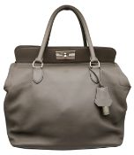 A Hermès Toolbox Handbag. Etain grey leather exterior with silver-tone hardware, double rolled