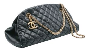 A Chanel Mademoiselle Bowling Bag. Black diamond-quilted leather exterior with gold-tone hardware,
