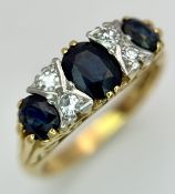 An 18K Yellow Gold, Diamond and Sapphire Ring. Three oval cut sapphires 0f 1ctw with diamond