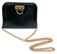 A Black Salvatore Ferragamo Gancini Chain Shoulder Bag. Black smooth leather exterior with gold-tone